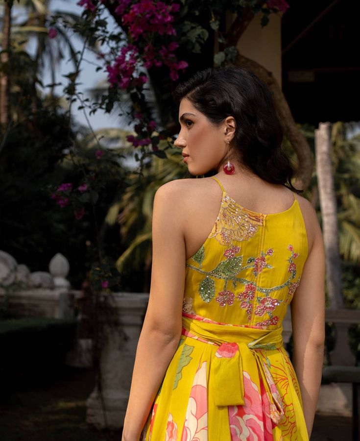 Editor's Note Featuring a lime yellow big floral jumpsuit with details of dramatic, flowy and easy breezy silhouette. The bodice is hand highlighted on digitally printed flowers using tone to tone sequins, moti, mirror and cutdana. It is styled with same printed belt to accentuate the waist Color: Yellow Fabric: Crepe Component: Jumpsuit and belt Fit: Attached lining fitted at waist, back opening Occasion: Resort and daywear Kaftan Length: 58" inches Care: Dry Clean Only About the Designer Paulm Green Floral Print Jumpsuits And Rompers For Party, Fitted Floral Embellished Maxi Dress For Summer, Festive Floor-length Jumpsuits And Rompers For Summer, Yellow Floral Embroidered Floor-length Dress, Festive Maxi Length Jumpsuits And Rompers, Yellow Floral Embroidery Floor-length Dress, Yellow Floor-length Dress With Floral Embroidery, Sleeveless Floral Print Jumpsuits For Party, Sleeveless Floral Print Party Jumpsuits And Rompers