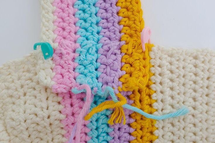 three crocheted pieces of yarn are next to each other