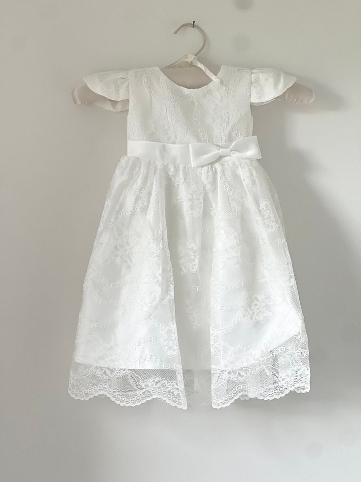 Beautiful and elegant baby girls' lace baptism dress. Delicately embroidered cap-sleeve gown perfect to be paired with any of our coordinating headbands. Complete with a linen and cotton blend liner, to ensure comfort. Fitted Lace First Communion Dress, Fitted Lace Dress For First Communion, Lace First Communion Dress With Lace Sleeves For Confirmation, Baptism Dress With Lace Sleeves For First Communion, Fitted Baptism Dress With Lace Bodice For First Communion, Short Sleeve First Communion Dress With Lace Bodice, First Communion Dress With Lace Patchwork, Fitted Lace Baptism Dress For Ceremony, Fitted Lace Baptism Dress