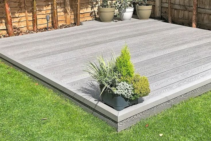 a wooden deck with potted plants on it