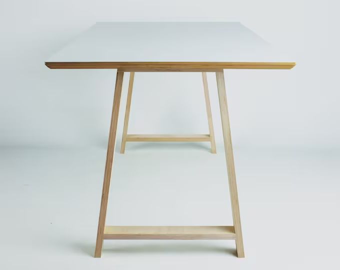 a white table sitting on top of a wooden shelf next to a white wall and floor