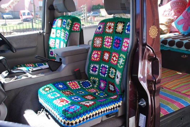 the interior of a car with a crocheted seat cover