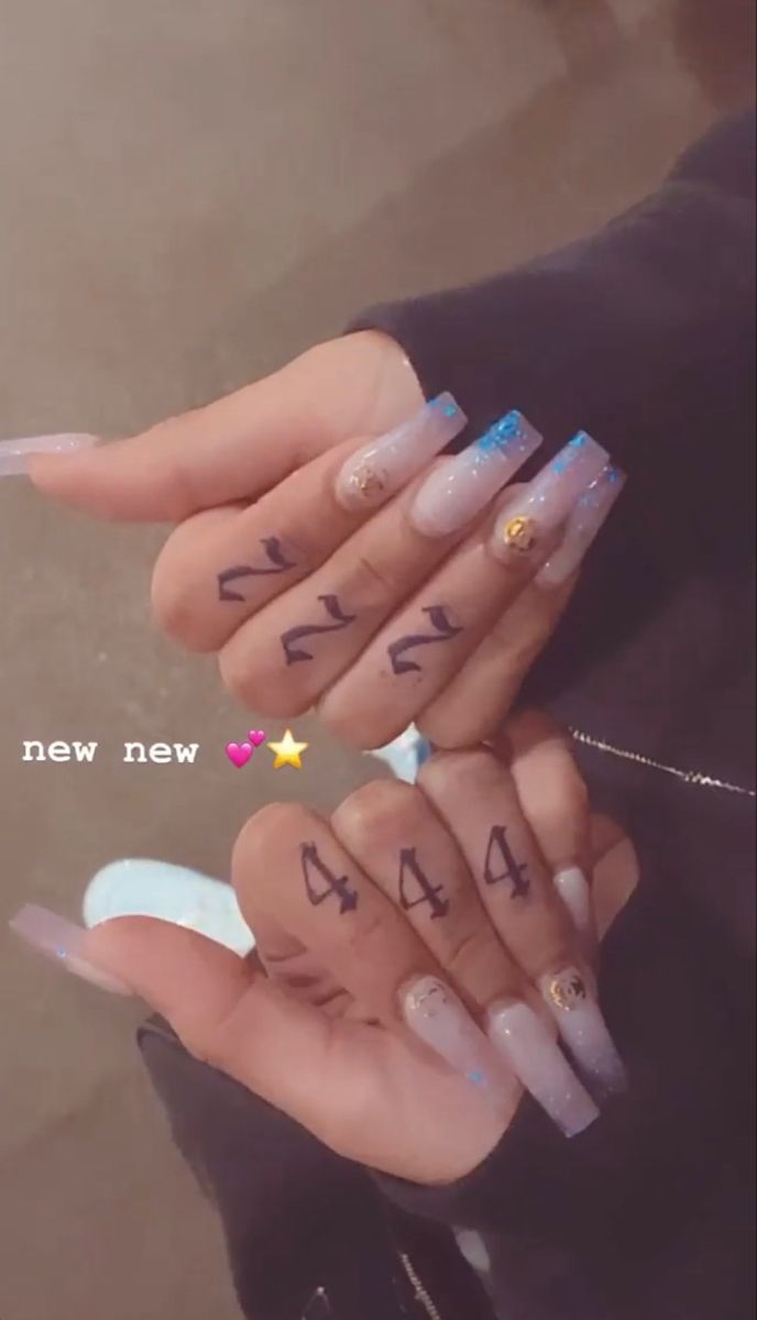 two hands with numbers written on their fingers