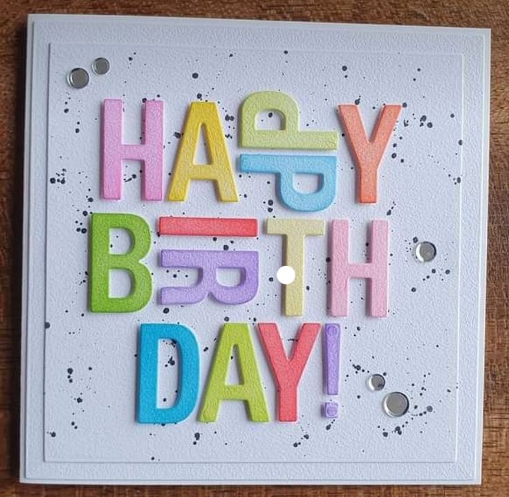 a card with the words happy birthday written in multicolored letters on white paper