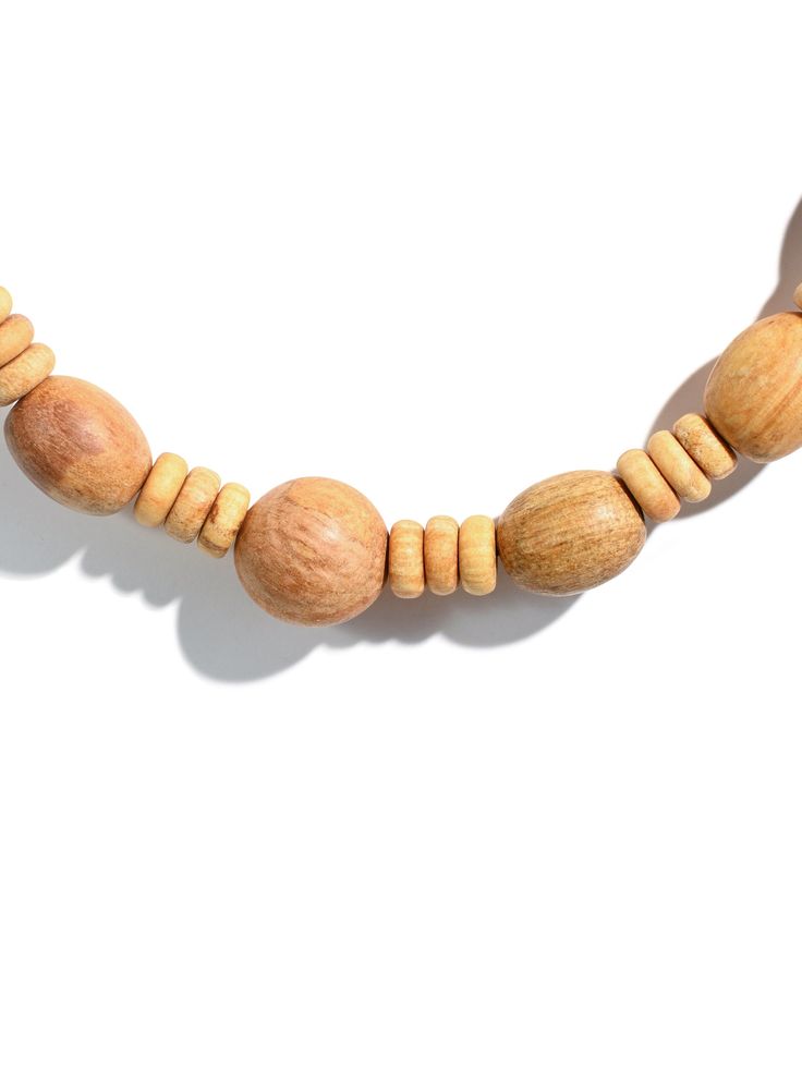 Our fragrant Palo Santo bead necklace is hand carved and very aromatic. The beads are strung on a stretchy cord and are designed to fit over the head. The large beads measure approximately 14 mm in diameter. Crafted in Peru. Hand-strung Adjustable Natural Necklace, Adjustable Natural Beaded Necklace With Large Beads, Adjustable Natural Color Necklaces With Round Beads, Adjustable Natural Round Beads Necklaces, Natural Wooden Beads Necklace, Hand-strung Necklaces With Round Natural Beads, Natural Hand-strung Necklaces With Round Beads, Natural Colored Hand-strung Necklaces With Round Beads, Natural Color Hand-strung Necklaces With Round Beads