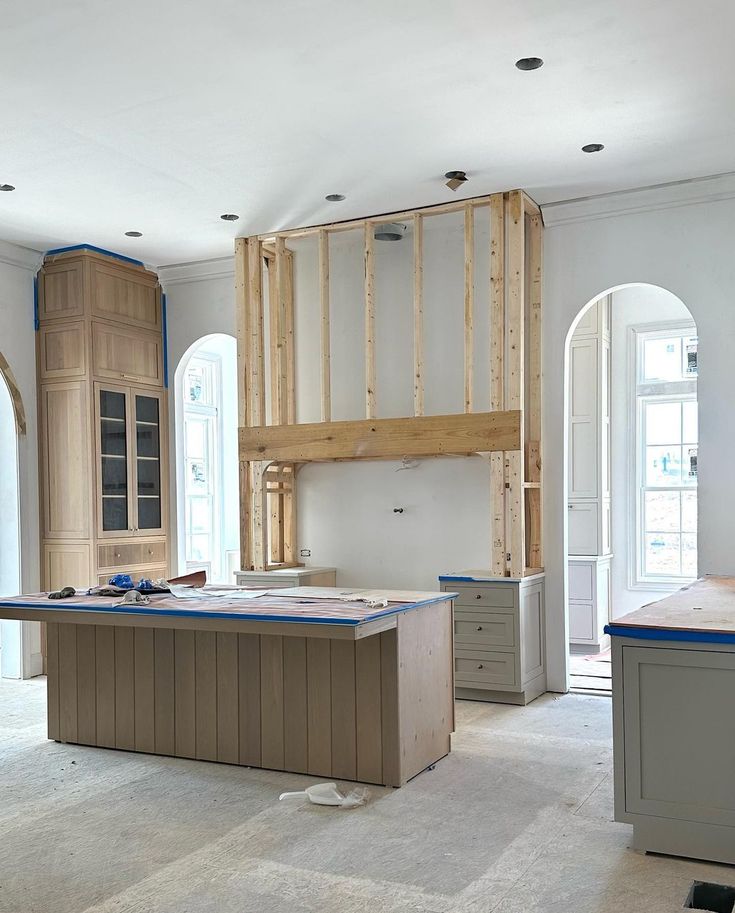 an unfinished kitchen with cabinets and counters in the middle