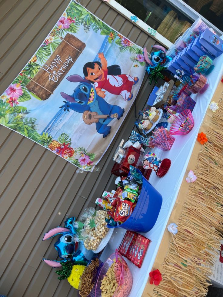 the table is set up with many items for children's birthdays and parties