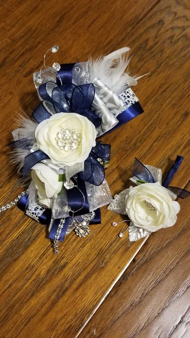 two bridal bouquets sitting on top of a wooden table