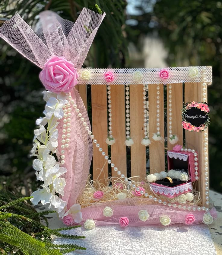 a pink and white doll house with flowers