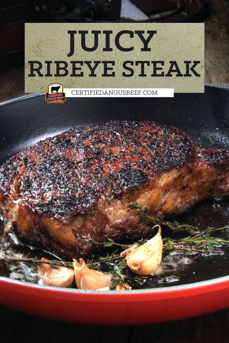 juicy ribeye steak cooking in a skillet