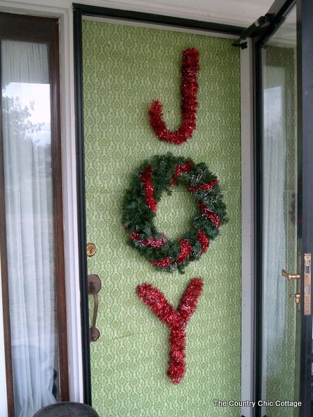 a door with a wreath and the word joy on it