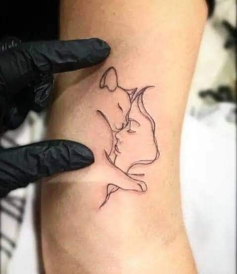 a woman's leg with a tattoo on it that has a drawing of a kissing couple