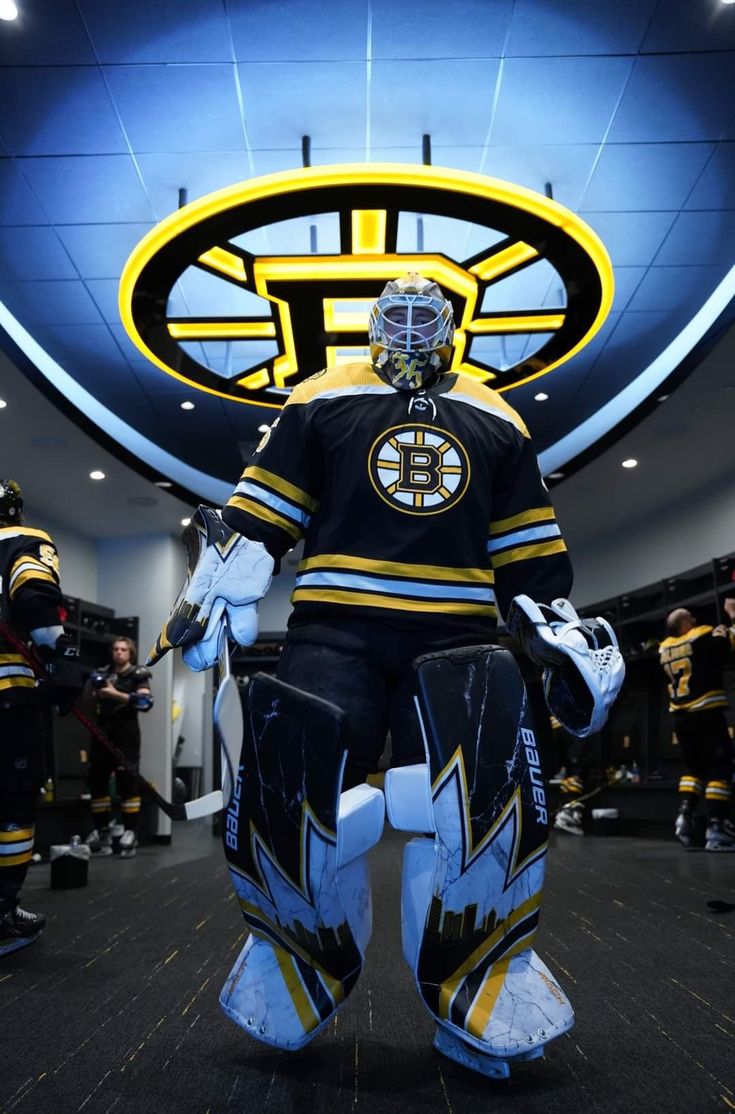 an ice hockey goalie is standing in the locker room