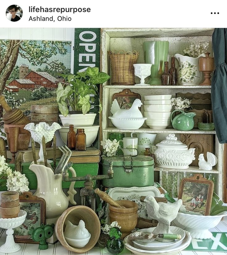 a room filled with lots of green and white dishes, vases and other items