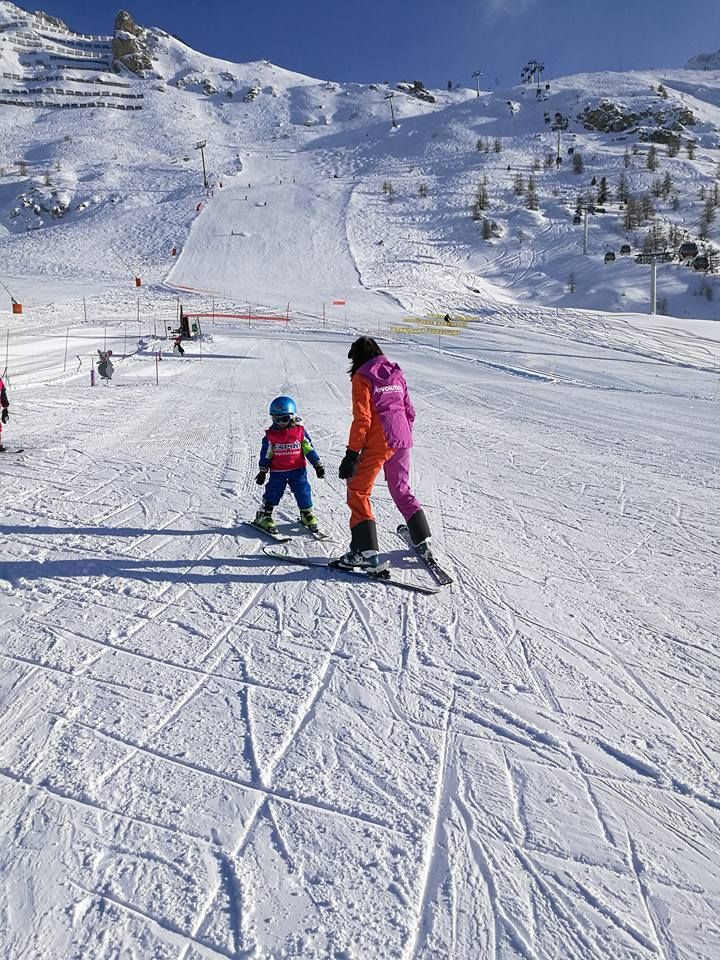 two people on skis in the snow