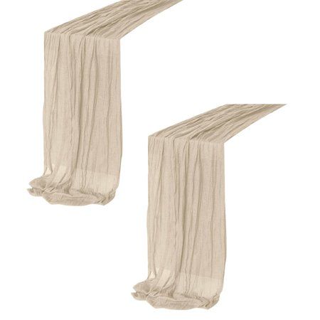 two long white sheer curtains hanging from the side of each other on a white background