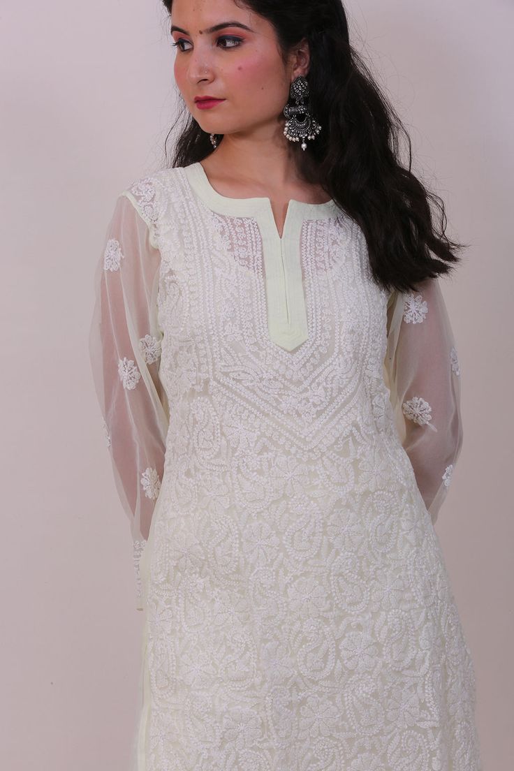 This hand embroidered Leher Georgette Kurti is a beautiful piece to wear at brunch, casual outings and other special occasions.It can be teamed up with hand emboidered chiaknakri pant, sandals and matching earrings to make your getup complete.The color combination with white embroidery is perfect to fit any occasion and comes with matching inner to make you look glamorous. Off White Traditional Wear For Spring Wedding, Festive Embroidered Top For Eid, Zari Work Embroidered Top For Eid, Eid Floral Embroidered Top With Straight Kurta Shape, Festive Embroidered Straight Kurta For Eid, Elegant Embroidered Top For Eid, Spring Resham Embroidered Straight Kurta Top, Spring Resham Embroidered Straight Kurta, Fitted Off White Kurta With Floral Embroidery