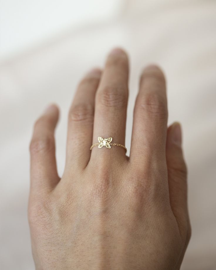 "Dainty 14k gold butterfly chain ring Made with 14k solid gold and 7mm butterfly Dainty light chain ring style \"Just like the butterfly, I too will awaken in my own time.\" ■ SHIPPING UPGRADES You can find shipping upgrades options in the drop bar menu when you check out. * Within the U.S Regular First-class : 2-6 business days Priority : 2-3days Express : 1-2 days * International International Priority : 6-10 Business days Rush International Express : 3-6 business days * Our current processing 14k White Gold Butterfly-shaped Jewelry, 14k White Gold Butterfly Jewelry, Dainty Butterfly Charm Jewelry For Wedding, Fine Jewelry Butterfly-shaped Yellow Gold Jewelry, Dainty Wedding Jewelry With Butterfly Charm, Fine Jewelry Yellow Gold Butterfly, 14k Gold Butterfly Jewelry For Anniversary, 14k Gold Jewelry With Butterfly Charm For Anniversary, Fine Jewelry Butterfly Shape For Wedding