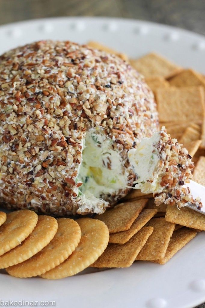 a cheese ball with crackers on a plate