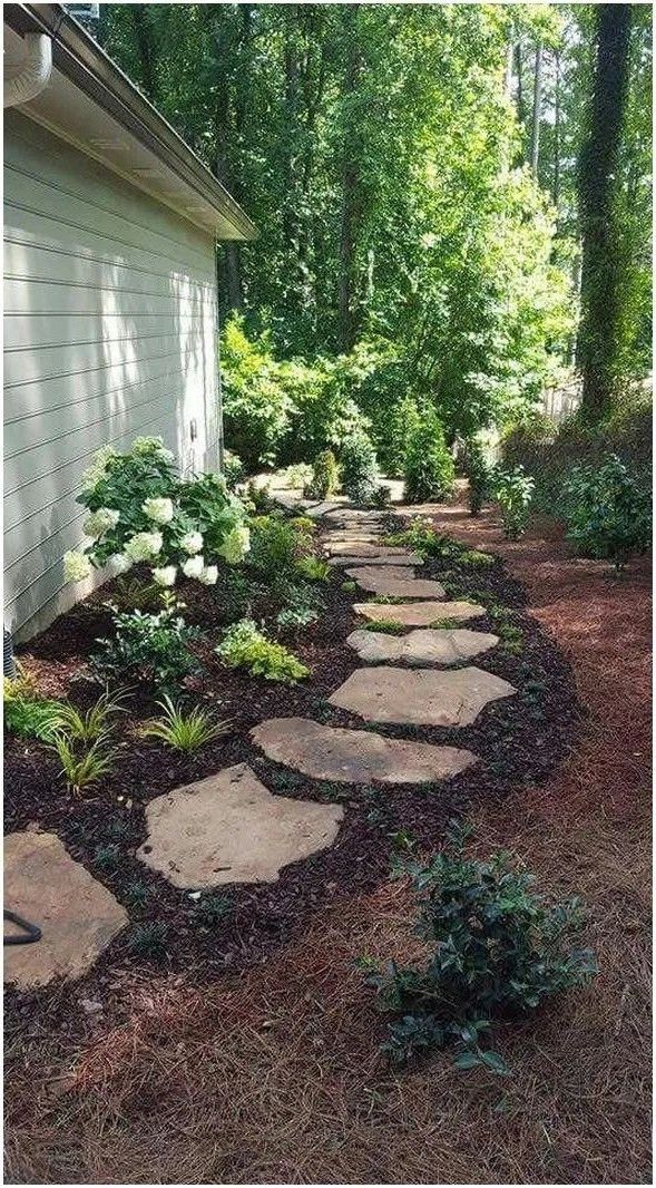 a stone path in the middle of a yard