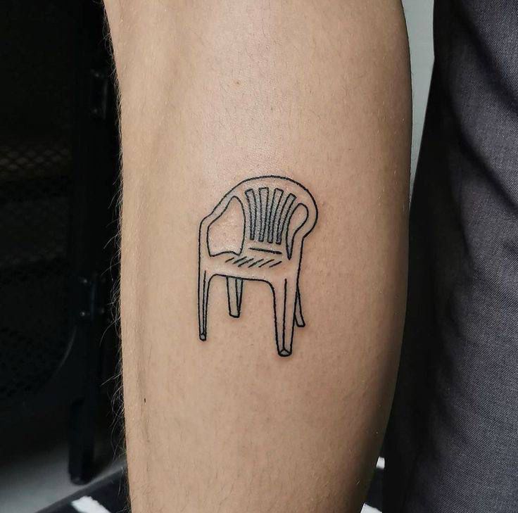 a black and white photo of a chair tattoo