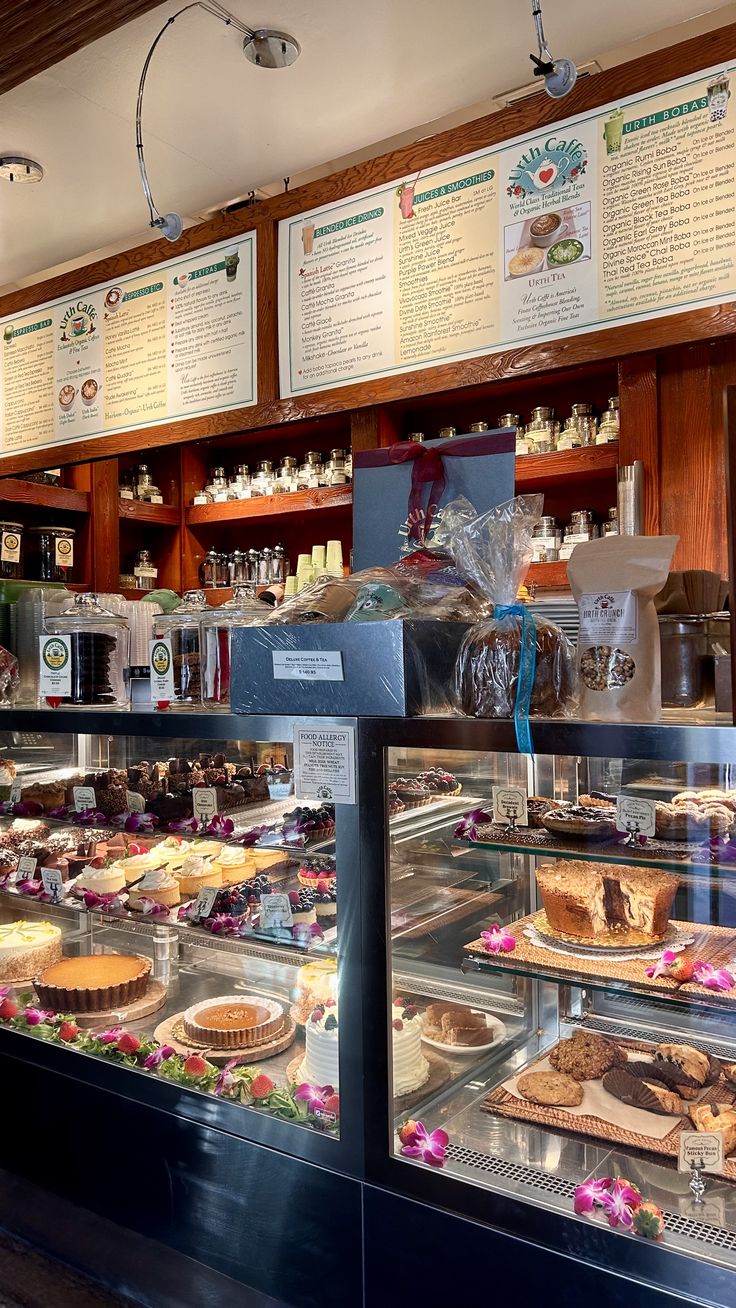 a bakery filled with lots of different types of pies on display in front of the counter