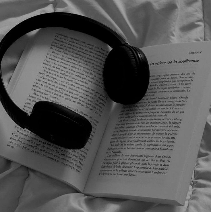 an open book with headphones on top of it