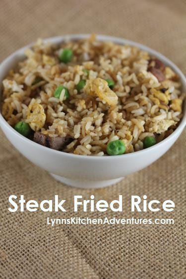 a bowl filled with rice and peas on top of a brown table cloth next to a spoon