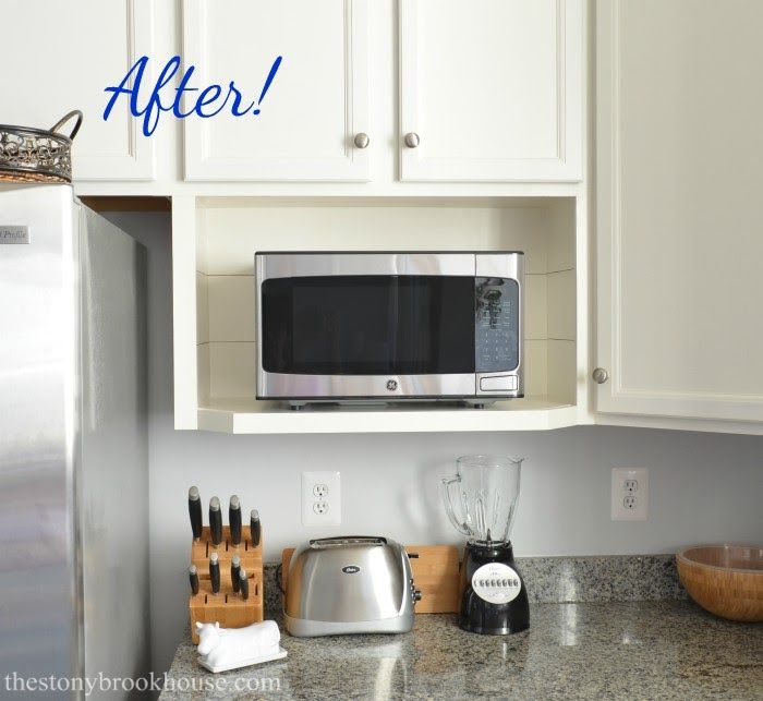 a kitchen counter with a microwave above it