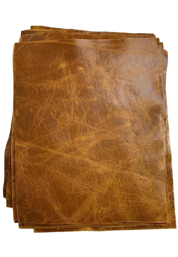 four brown leather napkins sitting on top of each other