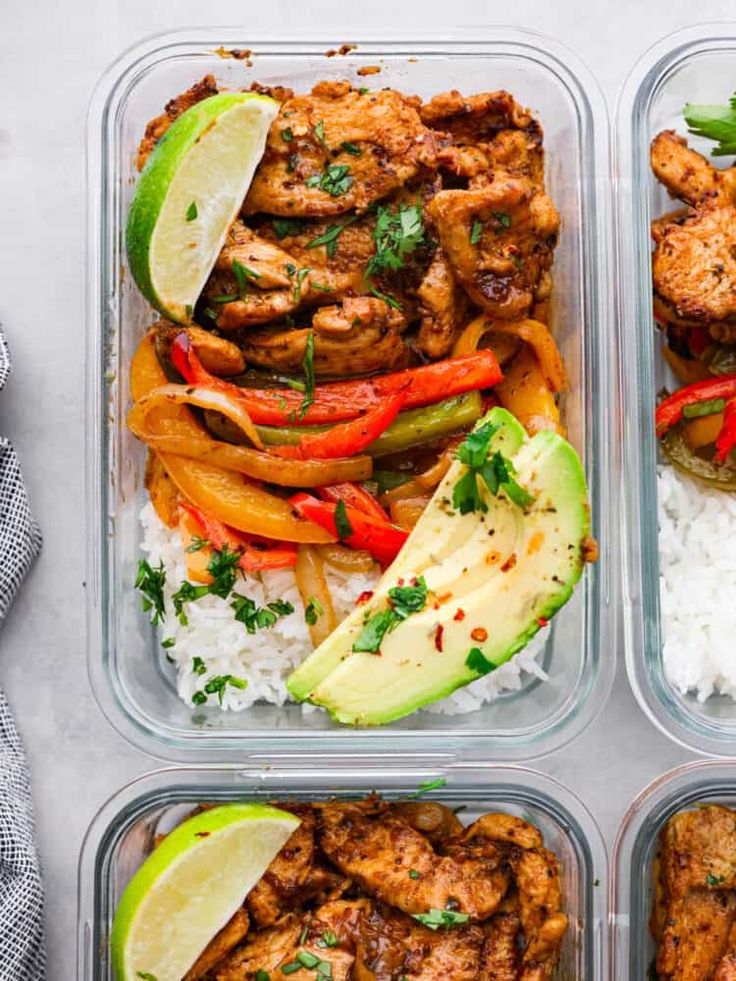 four plastic containers filled with chicken, rice and veggies on top of a table