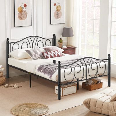 a bedroom with white walls and flooring has a metal bed frame in the middle