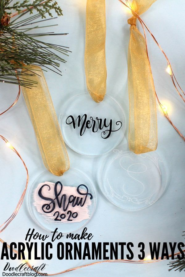 three acrylic ornaments hanging from a christmas tree with the words merry on them