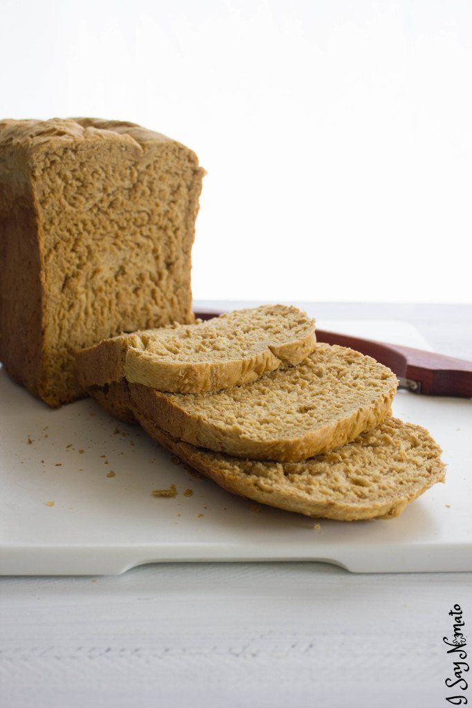 a loaf of bread sitting on top of a white cutting board next to a knife