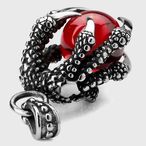 This Dragon's Gem necklace depicts a dragon claw grasping a priceless gem from its hoard. Made with stainless steel, this striking necklace is great gift for loved ones who also enjoy dragons and fantasy.Materials: Stainless Steel, Synthetic Crystal Pendant Size: 4.3 x 2.0 cm (1.7" x 0.7")Chain Length: ~50cm (19.6") Click ADD TO CART To Order Yours Now! The Checkout Process is Guaranteed to be 100% Safe and Secure with Visa, Mastercard, AMex, Discover, Apple Pay or PayPal. Silver Metal Jewelry With Claw Shape, Gothic Claw Shaped Jewelry Gift, Gothic Claw Jewelry Gift, Gothic Claw Jewelry For Gifts, Gothic Metal Jewelry With Dragon Design, Red Fantasy Metal Jewelry, Fantasy Red Metal Jewelry, Gothic Metal Round Pendant Jewelry, Metal Dragon Design Jewelry Gift