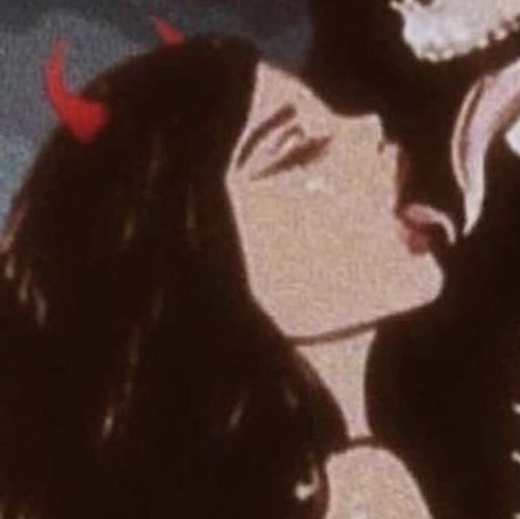 a man and woman kissing each other in front of a screen with red birds on it