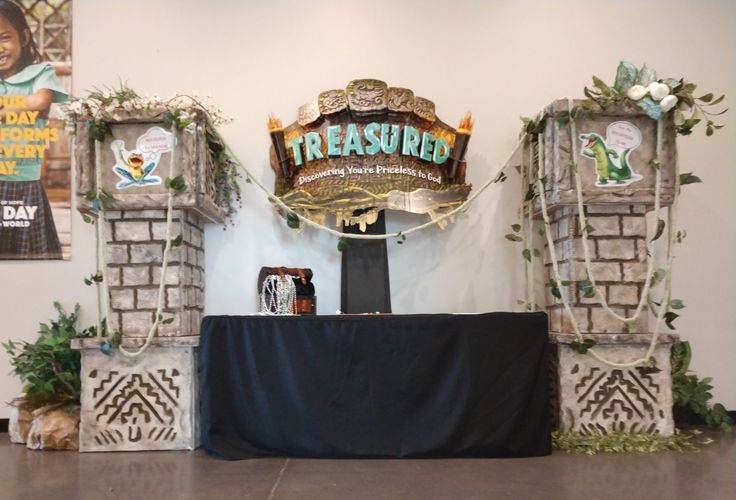 there is a sign on the wall that says tressue and it's decorated with greenery