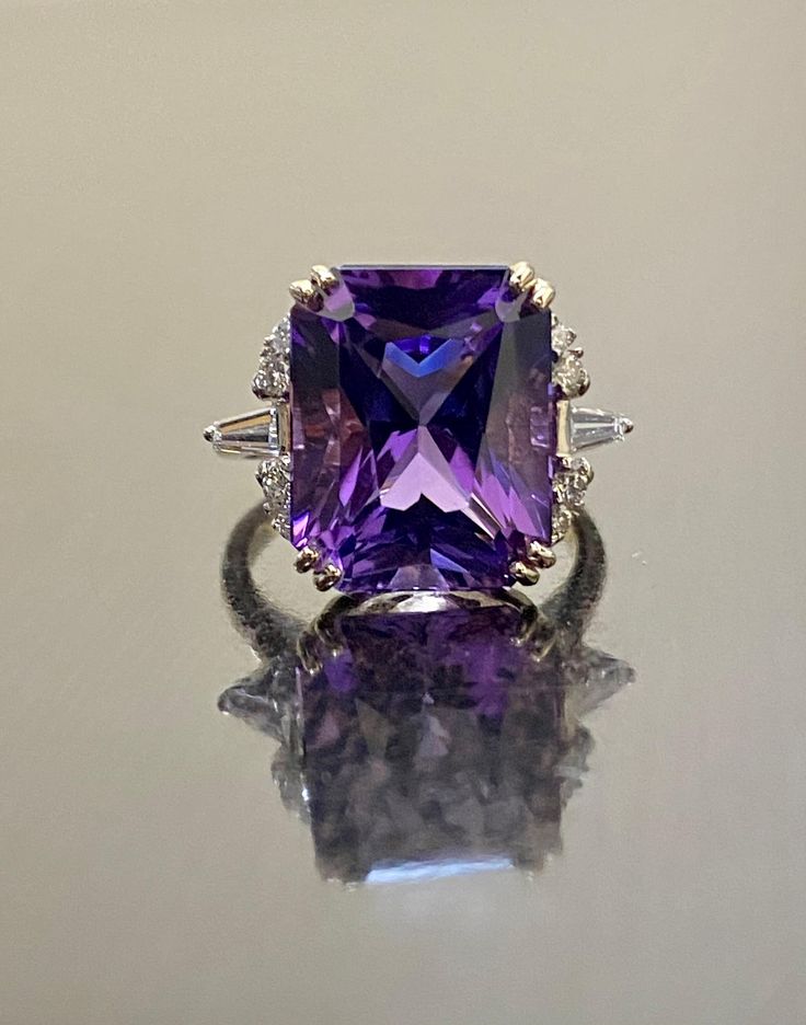 DeKara Designs Collection  Metal- 14K Rose Gold, .583. Stones- Natural Radiant Cut Amethyst 9.12 Carats, 2 Tapered Baguettes, 8 Round Diamonds G-H Color VS2 Clarity, 0.35 Carats. Size- 6 3/4.  FREE SIZING Beautiful Handmade Art Deco Inspired Baguette and Round Diamond Radiant Cut Amethyst Engagement Ring Made in 14K Rose Gold.  This ring features a beautiful specially cut radiant cut Amethyst that is professionally set in between four double prongs.  The Amethyst has prong set baguette and round Luxury White Gold Amethyst Ring With Gemstone Accents, Luxury Wedding Gemstones With Accents, Luxury Emerald Cut Amethyst Ring For Formal Occasions, Luxury Emerald-cut Amethyst Ring For Formal Events, Luxury Amethyst Ring With Emerald Cut Diamond, Luxury Emerald Cut Amethyst Ring With Diamond Setting, Luxury Emerald-cut Diamond Amethyst Ring, Elegant Purple Diamond Ring With Gemstone Accents, Luxury Emerald Cut Amethyst Wedding Ring