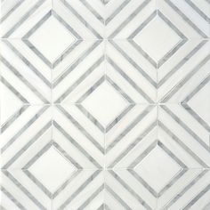 a white and grey tiled wall with lines