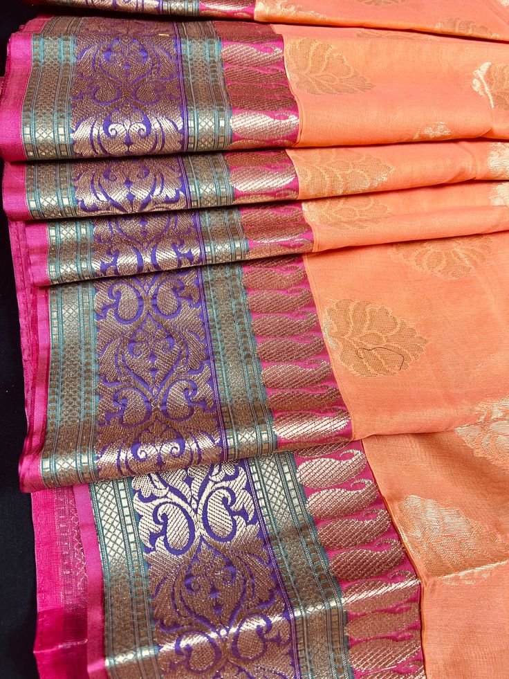 Premium Quality Cotton Silk Saree in Light Peach color with Banarasi borders. Item: SareeColor : Peach with Pink, Green adn Purple on the Border and Green Pallu Base Fabric: Soft Cotton Silk Blouse piece : Comes with Blouse piece.Blouse material: Cotton Silk Fall & Edging: (Yes/No) : YesDisclaimer -:- Color variation is possible due to various reasons like phone or desktop setting, resolution etc. Please don't hold us responsible. Our aim is to put the exact color of the Saree.- If the Saree is Traditional Semi-stitched Peach Saree, Traditional Peach Saree For Navratri, Peach Chanderi Traditional Wear With Pallu, Peach Saree With Zari Weaving For Puja, Traditional Banarasi Silk Wear In Peach, Traditional Peach Banarasi Silk Wear, Peach Saree With Zari Weaving For Diwali, Festive Peach Banarasi Silk Traditional Wear, Peach Saree With Zari Weaving