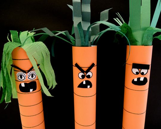 three carrots with faces painted on them