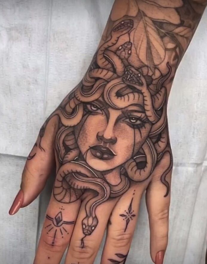 a woman's hand with tattoos on it