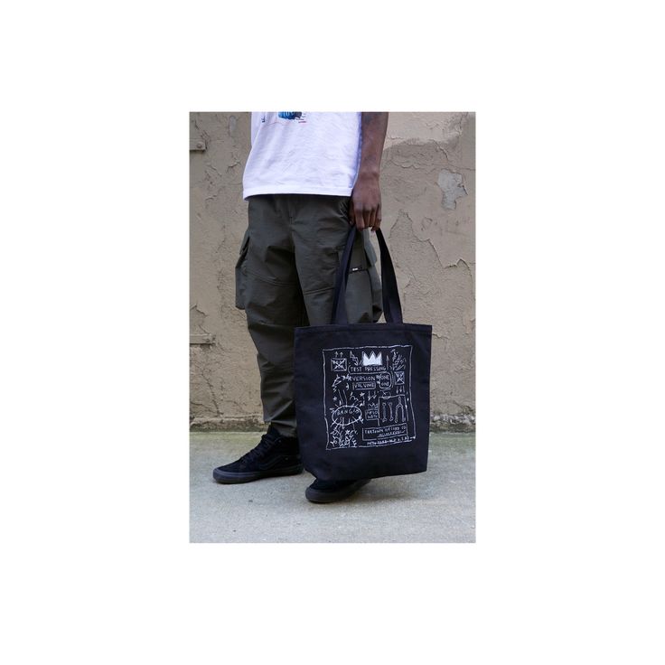 Our oversized tote bag is designed to be durable for your daily needs.The front and back are adorned with Basquiat's album cover artwork Beat Bop. 100% heavy duck canvas in black Lined with 100% cotton Cotton webbing handles 18x17 inches (45.7x43.2 cm) Made in the USA About the artwork: One of Jean-Michel Basquiat's most coveted works is from the record album artwork of the early hip-hop record Beat Bop that JMB produced and self-financed. Released under his own Tartown record label, the origina Black Bags With Graphic Print For Streetwear, Black Graphic Print Bags For Streetwear, Black Graphic Print Bag For Streetwear, Rectangular Canvas Streetwear Bags, Rectangular Canvas Bags For Streetwear, Casual Black Bags With Graphic Design, Urban Tote Bag For Streetwear, Urban Streetwear Tote Bag, Black Cotton Canvas School Bag