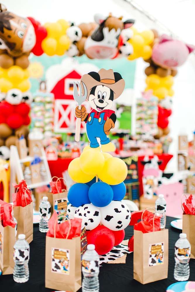 a mickey mouse birthday party with balloons and decorations