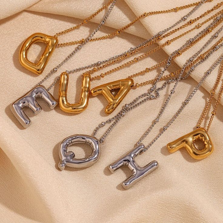 Add some playful personalization to your summer wardrobe with our Bubble Letter Necklace! This quirky accessory is a perfect gift for her, adding a fun touch to any outfit. Layer it up for a fun #neckmess! DETAILS & SIZE Finish: 18K gold plate Materials: 316L Stainless Steel Measurements: Pendant: 19.4x14.4mm; Chain: 16" + 2" extension Lobster claw clasp Waterproof, tarnish-resistant, and nickel free. Shop Necklaces for more options! Bubble Letter Necklace, Balloon Letters, Gold Initial Necklace, Bubble Letter, Letter Pendant Necklace, Initial Necklace Gold, Letter Balloons, Waterproof Jewelry, Gold Initial