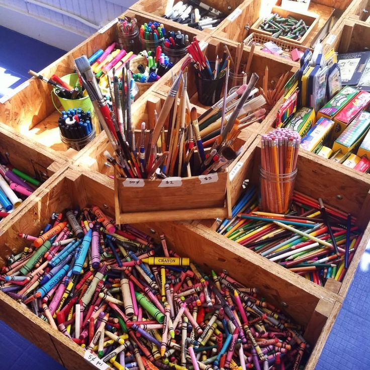 several wooden boxes filled with lots of colored pencils