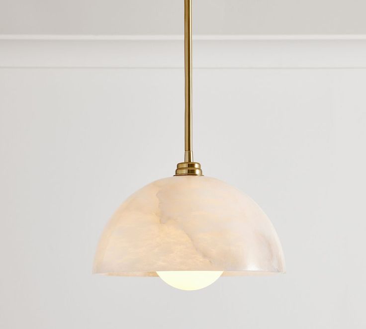 a light fixture hanging from the ceiling in a room with white walls and flooring