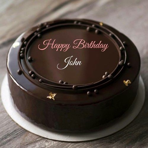 a chocolate birthday cake sitting on top of a white plate with the words happy birthday to your name here