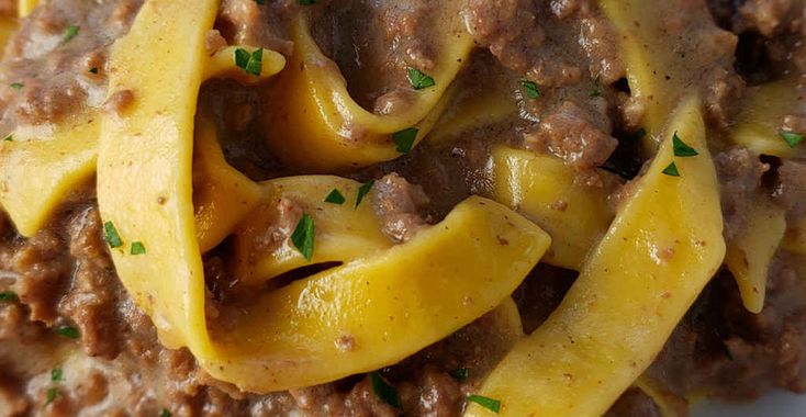 pasta with meat sauce and parsley on top