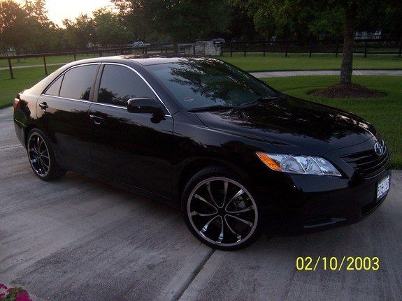 a black car is parked on the street